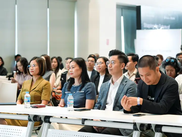 The audience fills the front rows, attention fixed on the stage