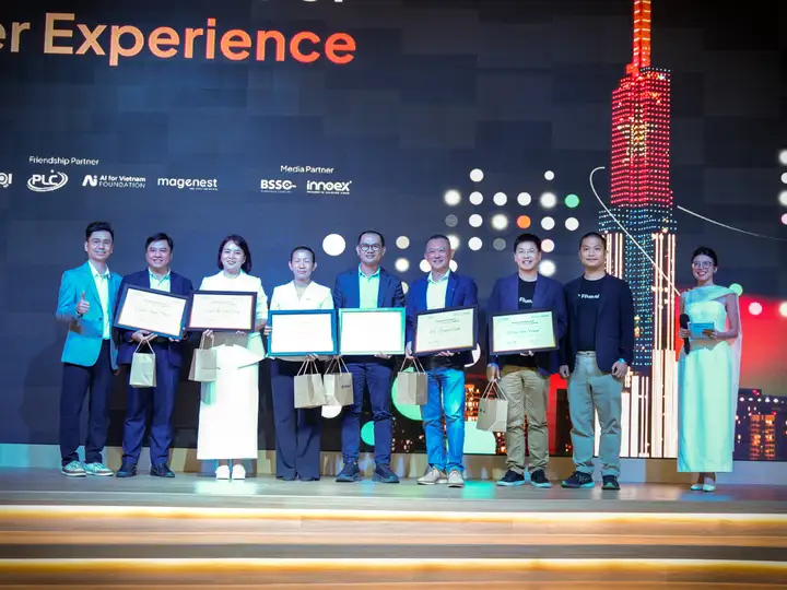 Representatives of supporting organisations receiving commemorative plaques on stage